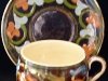 Aller Vale Pottery Cup & Saucer with scrolls on dark brown ground