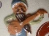 Aller Vale Pixy, playing a banjo, sprigged on a jug