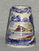 Devon Tors jug 3” high in blue and white with coloured cartouche of Devon scene